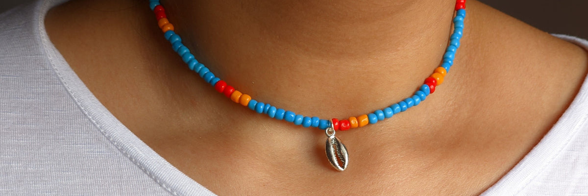 Colorful beaded choker necklace with a silver shell charm